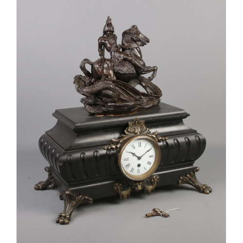 88 - A large mantel clock surmounted with a bronze sculpture depicting St George and the dragon and raise... 