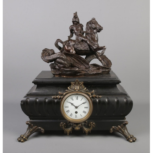 88 - A large mantel clock surmounted with a bronze sculpture depicting St George and the dragon and raise... 