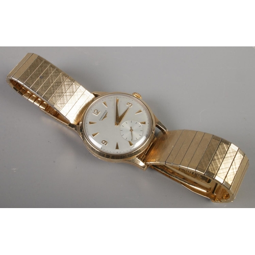 89 - A gents 9ct gold Longines manual wristwatch on stainless steel bracelet strap. Having baton and Arab... 