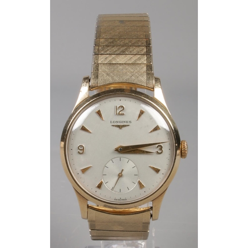 89 - A gents 9ct gold Longines manual wristwatch on stainless steel bracelet strap. Having baton and Arab... 