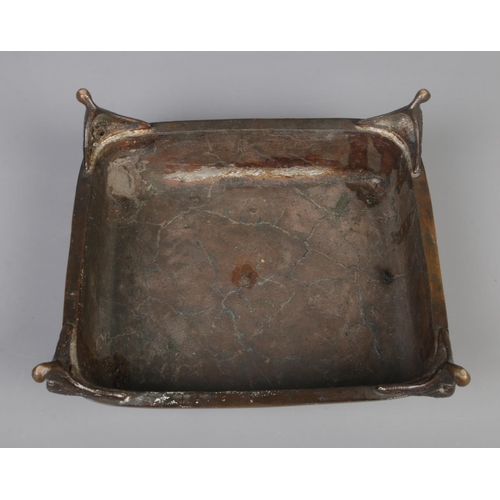 9 - A Japanese bronze desk stand formed as a seated man and a barrel raised on square plinth with scroll... 