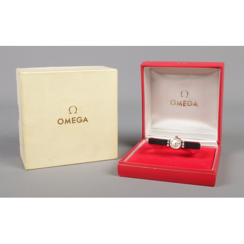 99 - A ladies gold and six stone diamond Omega manual wristwatch.