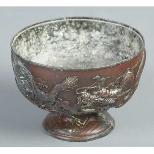 187 - A Chinese bronze pedestal bowl decorated with dragons. (15cm diameter)