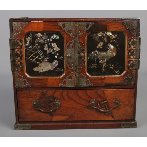 188 - A Chinese wooden jewellery box with marquetry and abalone shell inlay. Metal bound doors and interio... 