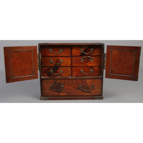 188 - A Chinese wooden jewellery box with marquetry and abalone shell inlay. Metal bound doors and interio... 