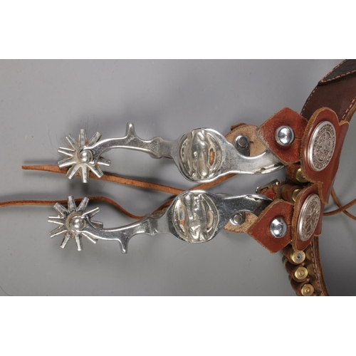 205 - A leather cartridge belt with cartridges, together with a pair of spurs.