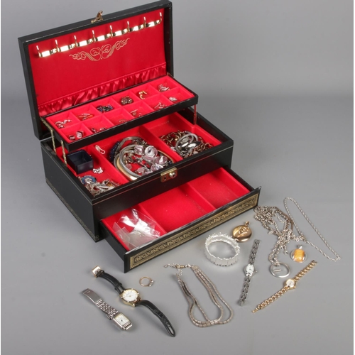 210 - A cantilever jewellery box and contents. Includes rolled gold and paste set ring, yellow metal & see... 