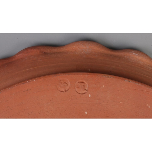 230 - A large glazed studio pottery charger. Stamped JL to base. Diameter 39cm.