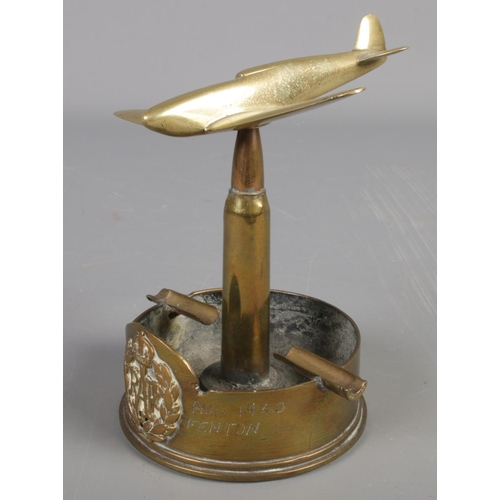 250 - A RAF brass trench art ashtray. Formed as a war plane at the top of a bullet. Baring broad arrow mar... 