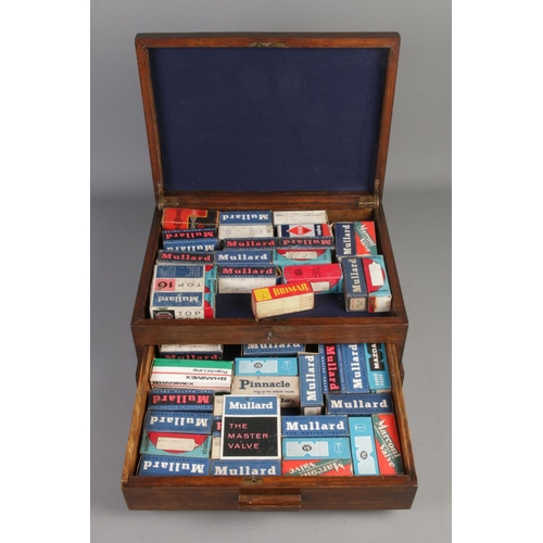 252 - An oak presentation case, with self-locking lower drawer, containing an assortment of boxed radio va... 