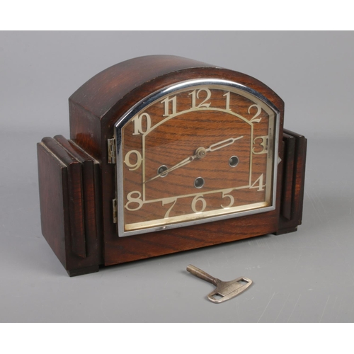 269 - A 1930s oak mantel clock. The movement marked Haller A. With pendulum and key.