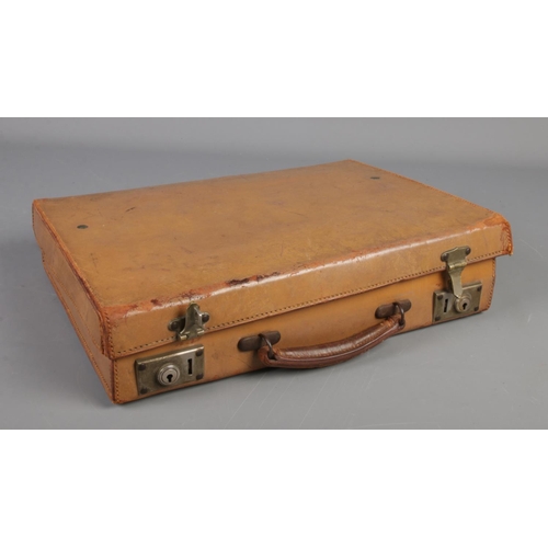 275 - A small leather case with contents of vintage costume jewellery and coins. Includes pheasant foot br... 