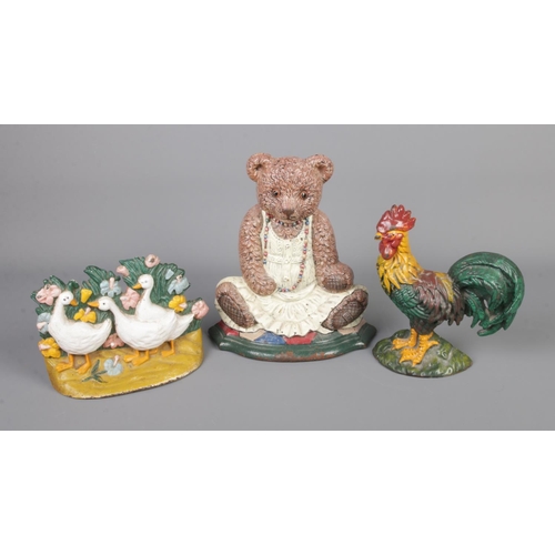 294 - Three cast iron doorstops in the form of a Rooster, group of Geese and Teddy Bear.