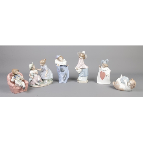 313 - Six Nao by Lladro ceramic figures, including cat with ball of string and mother and child on chair.