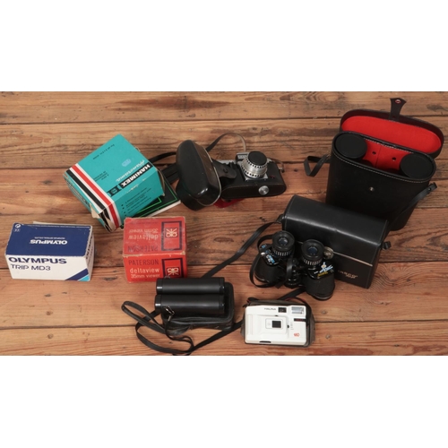 329 - A box of cameras and binoculars. Includes Tasco Zip binoculars, boxed Olympus Trip MD3, Praktica Nov... 