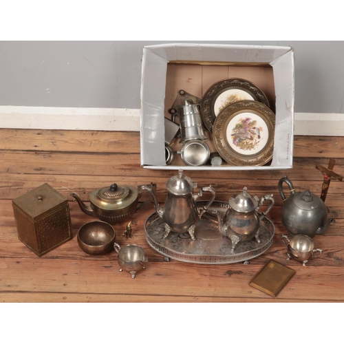 336 - A box of metalwares. Includes pewter teapot, eastern bowl, silver plated tray, etc.