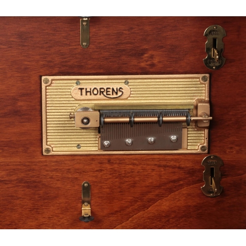 406 - A reproduction Thorens music disc player and cabinet decorated with musical and floral motifs. Inclu... 