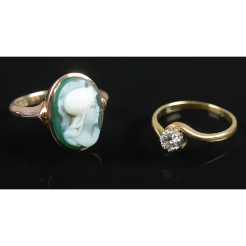 483 - Two 9ct gold rings. Includes one diamond example and the other cameo example. 4.98g gross.