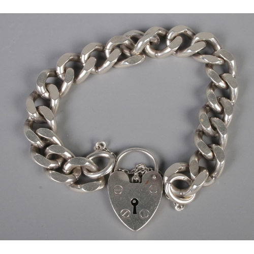 492 - A silver heavy link bracelet with heart shaped clasp. 49g.