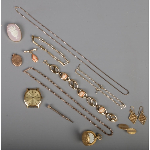 494 - A quantity of yellow metal jewellery. Includes 12ct front & back cuff link, locket, chains, bracelet... 