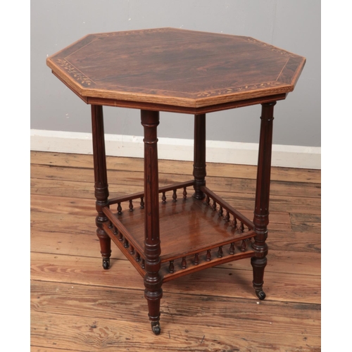 563 - A Victorian rosewood window table with inlaid and crossbanded decoration.