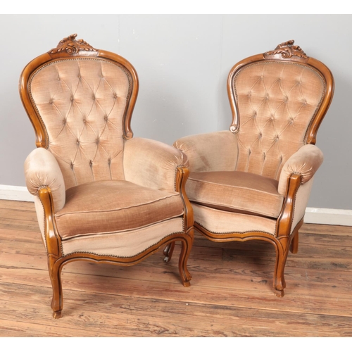 581 - A pair of French style hardwood arm chairs with deep button backs.