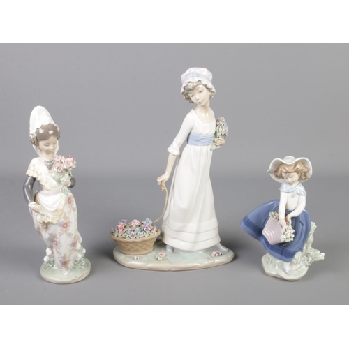 220 - A set of 3 Lladro figures of maidens.