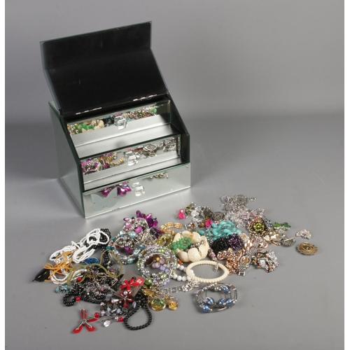 260 - A collection of costume jewellery in a mirrored jewellery box