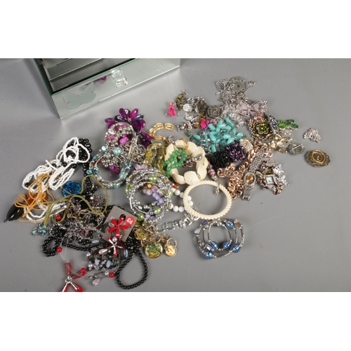 260 - A collection of costume jewellery in a mirrored jewellery box