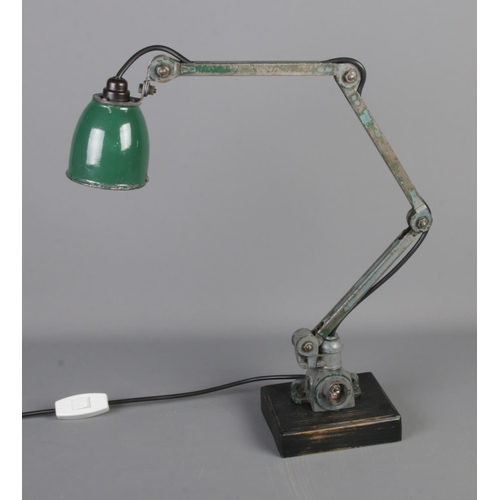 579 - A mid 20th century industrial anglepoise lamp with green enamel shade on wooden base.