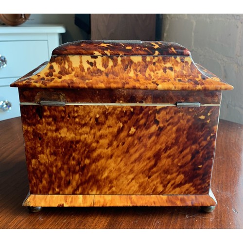 78 - A 19th century tortoise shell tea caddy raised on four bun feet. Having silvered banding and monogra... 