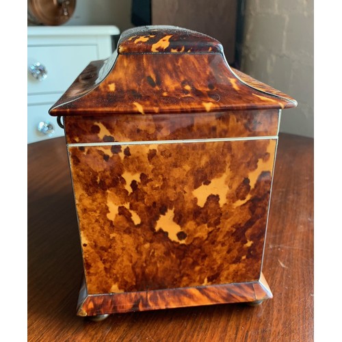 78 - A 19th century tortoise shell tea caddy raised on four bun feet. Having silvered banding and monogra... 