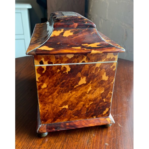 78 - A 19th century tortoise shell tea caddy raised on four bun feet. Having silvered banding and monogra... 