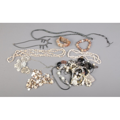 100 - A collection of costume jewellery statement necklaces including shell and mother of pearl examples.