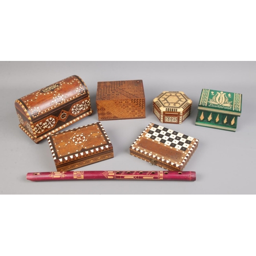 101 - A collection of treen including decorative boxes, travel chess set and woodwind instrument.