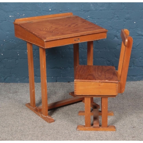 544 - A Taylor's of Leicester child's hinged top desk and chair.