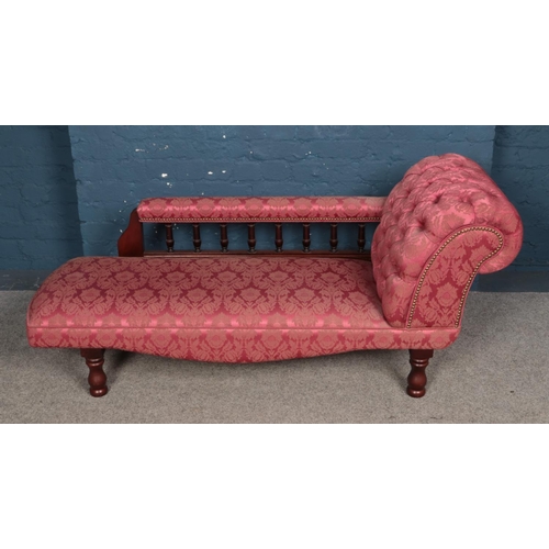 555 - A modern brocade upholstered chaise longue.