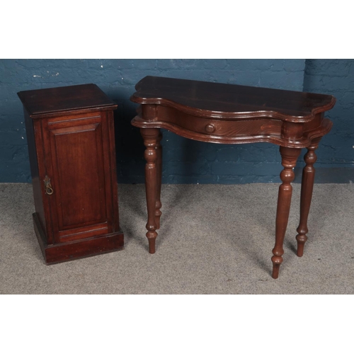 558 - A mahogany bedside cabinet along with demi-lune side table with singular drawer.