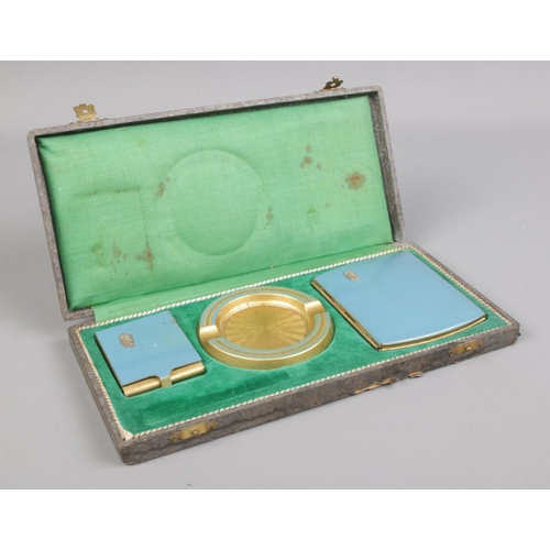 103 - A cased smoking set, including cigarette case, ash tray and match box.