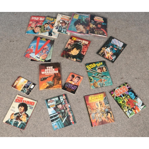 590 - A collection of sci-fi related annuals and books including Dr who, Star Trek and Star wars.