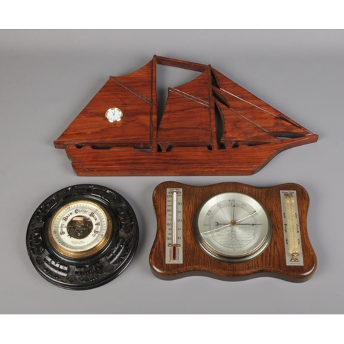 11 - A Winter & Sons aneroid wall barometer along with similar barometer and wall clock formed as a ship.