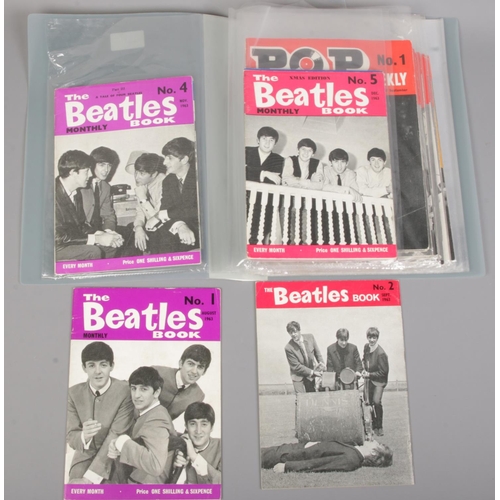 619 - A folder containing music magazines. Includes The Beatles Book Monthly No.1-7, approximately 30 Pop ... 