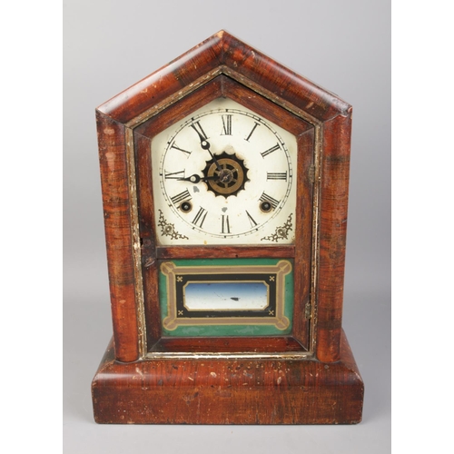 117 - An antique Gilbert 'Cottage' mantel clock. In working order with pendulum and key.