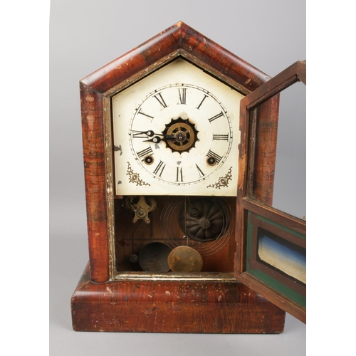 117 - An antique Gilbert 'Cottage' mantel clock. In working order with pendulum and key.