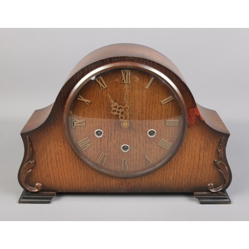 118 - A Smiths Art Deco style oak mantel clock featuring Westminster chime.