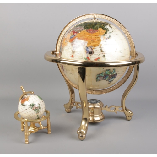 120 - Two modern gemstone globes on stands; with the largest having a compass in the base of the stand. He... 