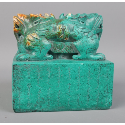 141 - A Chinese double dragon wax seal bearing character marks around base. 10cm x 11cm x 11cm.