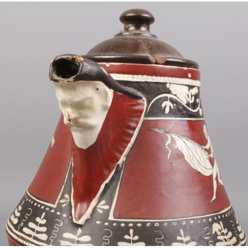 159 - A Greek jug decorated with classical figures and having mask spout. Label to base 'Neopolitan Count ... 