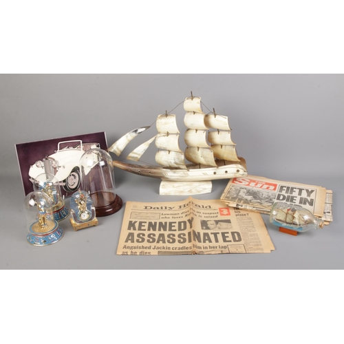 16 - An assortment of collectables and newspaper articles, to include assassination of JFK, ship in bottl... 