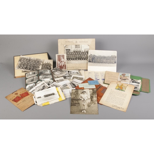 17 - A quantity of vintage photos and military ephemera, to include training notebook, part filled photog... 
